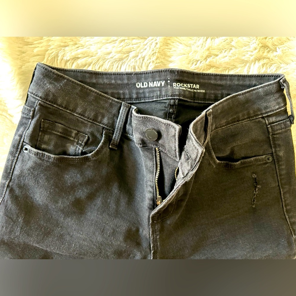 Pair of black distressed jeans